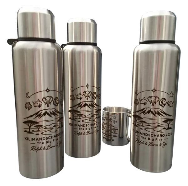 Three stainless steel bottles and a mug engraved with Kilimanjaro, the Big Five animals, and the text Kilimanjaro 2026 The Big Five.
