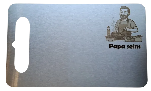 Isolated cutting board with an engraving of a man cooking and the inscription "Papa's."