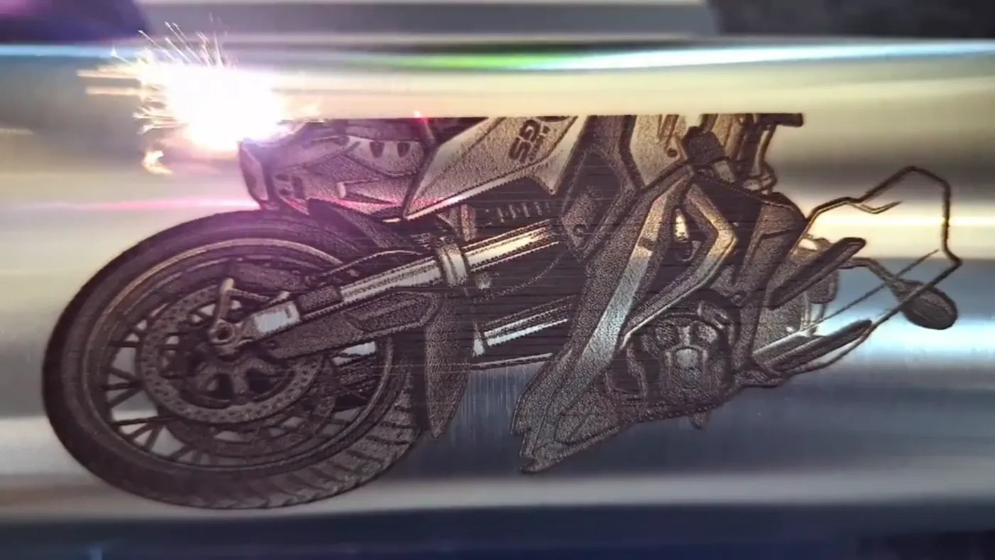 A fiber laser engraves a motorcycle motif onto a stainless steel bottle in the workshop in Freital.